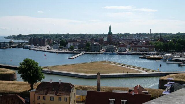 Experience Kronborg Castle and Elsinore from above. Capture the serene waterfront, architecture, and history of Denmark