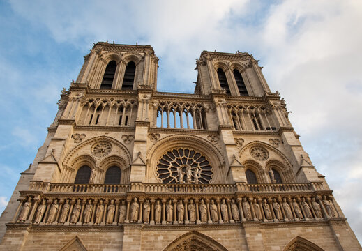 Notre-Dame de Paris Gothic cathedral facade under blue sky