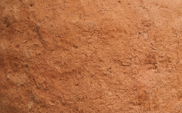 Terracotta clay texture background macro close up of a rustic earthenware pot surface with rough porous material for design and crafts