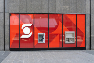 Obraz premium Toronto, Ontario, Canada - September 13, 2026: A Scotiabank exterior wall with an ATM and a night deposit slot behind a red branded glass facade. Toronto, Ontario, Canada. 