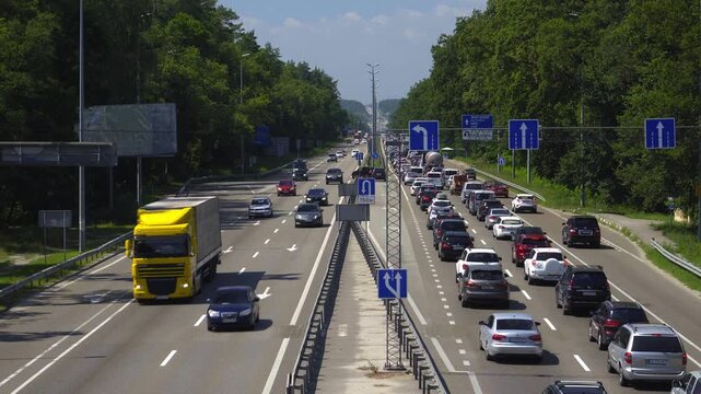 Busy Highway Traffic During Daytime Rush Hour With Congested Lanes and Moving Vehicles