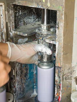 Manufacturing automotive aerosol paint cans in workshop