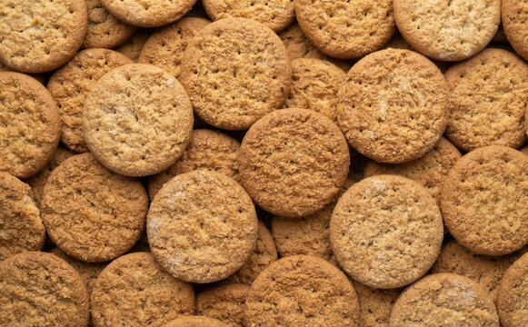 A stack of delicious freshly baked organic digestive biscuits arranged closely together for a delicious snack or breakfast concept