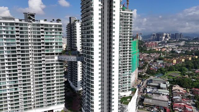 Modern futuristic architecture design of four high rise apartment towers linked by a circular skybridge in Malaysia