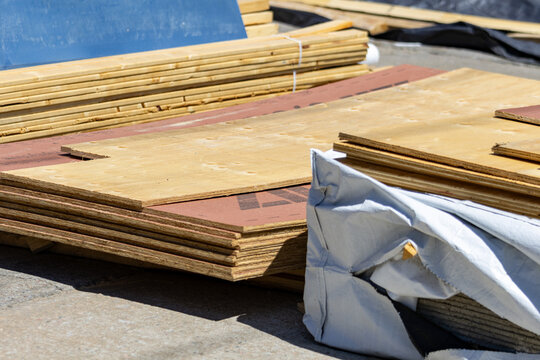 La Tuque, Quebec, 23 May 2026 : Stacks of plywood sheets and lumber planks are piled on a construction site.