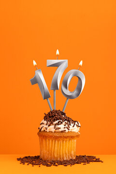 Birthday candle number 170 - Invitation card with orange background. Cupcake