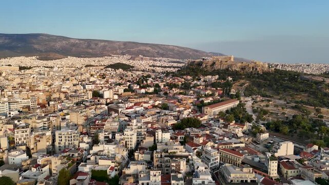 Aerial view captured by drone over the city of Athens in Greece. Flying toward the Acropolis. 