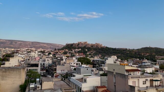 Low flying drone over the Greek city of Athens. Greece is a popular travel destination. An urban setting in a historical location with the Acropolis featured in the center. 