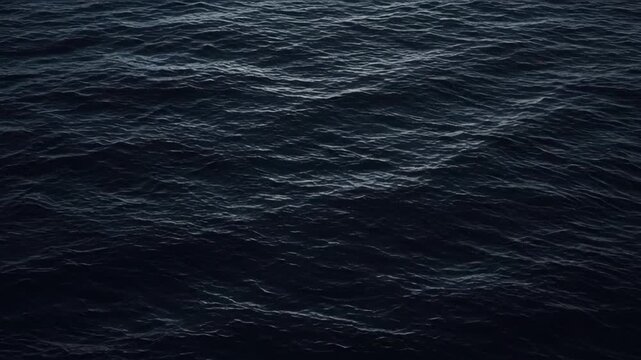 Dark blue sea surface with gentle wave texture, moody abstract ocean water background, subtle ripples, tranquil atmosphere, natural pattern for coastal design, reflection, and SEO visuals