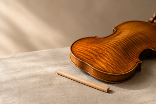 Violin back plate and soundpost on linen, classical music craftsmanship concept