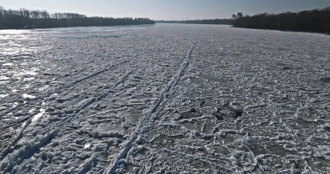 Aerial view of frozen floes on river in winter.