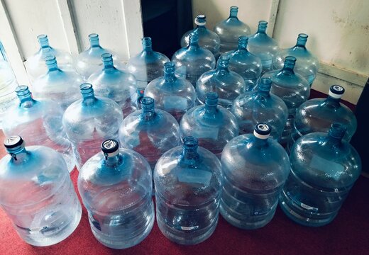 Bottle plastic water gallons arranged neatly for storage and distribution, representing clean drinking water supply, water delivery services, household consumption, and everyday hyd