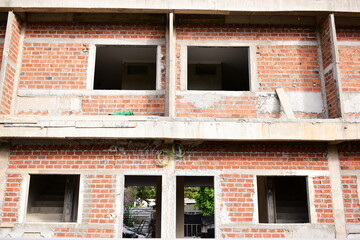 Obraz premium exterior view of brick house under construction with concrete structure