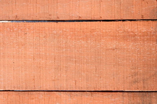 natural reddish brown wooden board texture background with visible screw