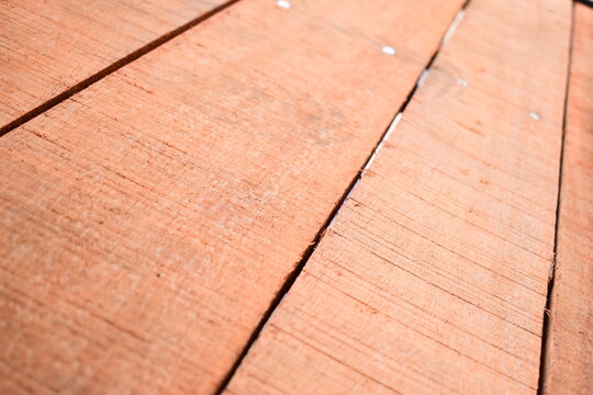 natural reddish brown wooden board texture background with visible screw