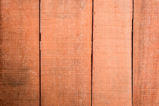 natural reddish brown wooden board texture background with visible screw