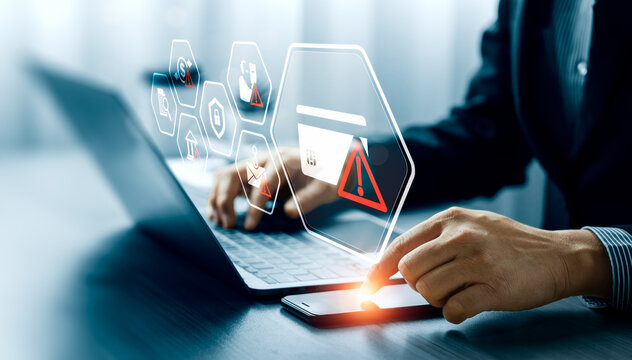 Fraud detection concept with business professional using smartphone and laptop showing credit card warning interface, phishing scam alerts, identity theft and financial risk protection