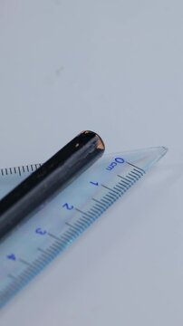 Vertical video: 40 degree isosceles right triangle ruler marked in centimeter. Study tool, math tool, student drawing tool.