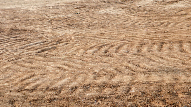 High angle shot of heavy tire treads on dry construction site dirt
