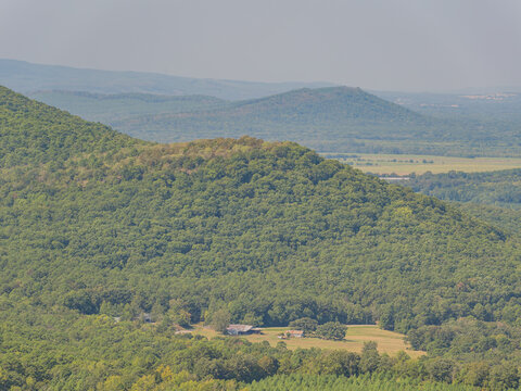 Forest covered mountain ridge with distant hills and valley