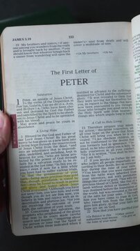 Opening to the book of 1 Peter, of the New Testament in the Holy Bible. New Revised Standard Version. Vertical video.
