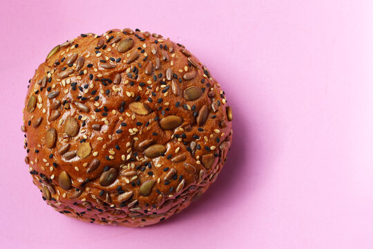 Healthy multigrain bread bun topped with mixed seeds and grains