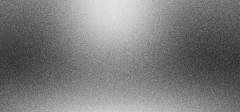 Brushed silver metal texture with soft overhead spotlight. Metallic aluminum background with subtle grain and gradient lighting. Industrial steel surface for product display and tech design.