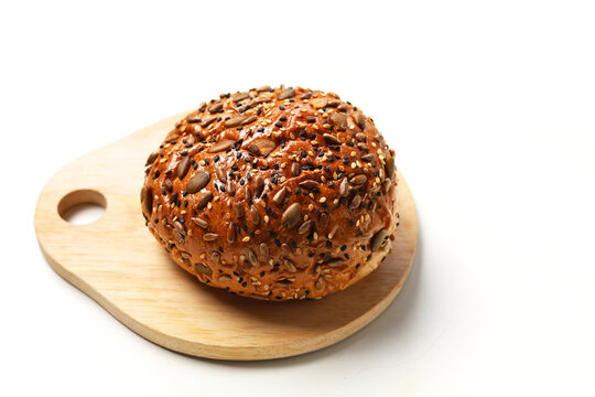 Healthy multigrain bread bun topped with mixed seeds and grains