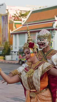 Performers Dancing Traditional Thai Khon in Ornate Costumes Outdoors