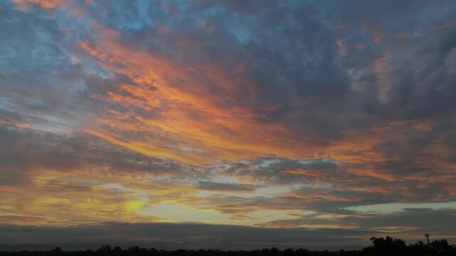 Golden sunrise over Mae rim district, Chiang Mai, Thailand spreads warm light across foggy suburbs.