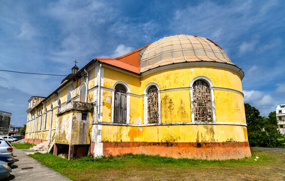 The exterior of the historic Catholic Church of the Immaculate Conception of Grand-Bourg with yellow facade in Marie-Galante, Guadeloupe, Caribbean France