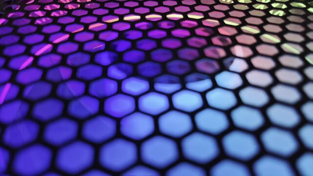 Abstract colorful hexagon mesh background with glowing neon rainbow lights. Futuristic digital honeycomb pattern loop for motion graphics  tech stage design  and EDM club backdrop.