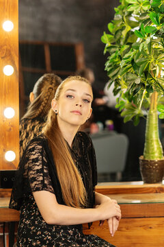 Teen Girl Posing With Finished Makeup Beside Salon Mirror