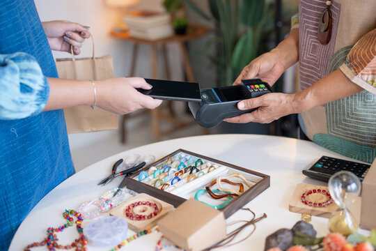 woman using smartphone for contactless payment with EDC payment representing digital finance and cashless technology adoption