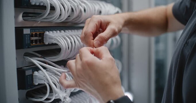 IT Specialist Removes Protective Jacket From Twisted Pair Network Cable, Preparing Colored Conductors for RJ45 Termination and Accurate Patch Cord Length During Structured Cabling Installation.
