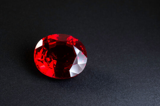 Red Ruby gemstone Round Cut isolate on black background, close up shot	
