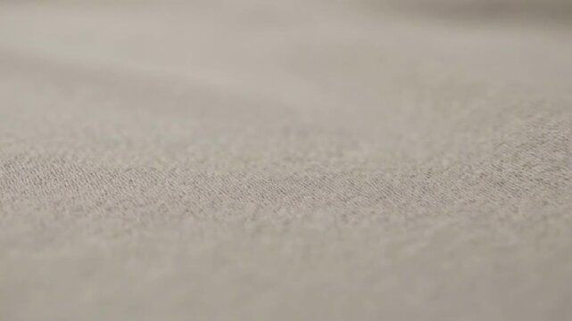 Close-up view of authentic soccer football jersey fabric texture showcasing intricate stitching and material composition under controlled studio li...