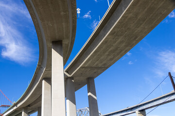 Obraz premium Concrete overpass bridges crossing against blue sky