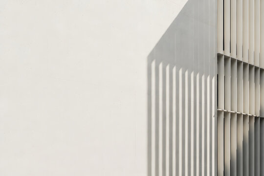 Vertical louver panel shadow cast on smooth wall surface, perfect for modern architectural exterior backdrop, banner, and copy space.