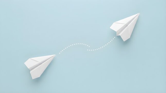 White paper airplanes soaring across a soft pastel blue background with a dotted path connecting both flying objects in a simple creative minimalist conceptual design