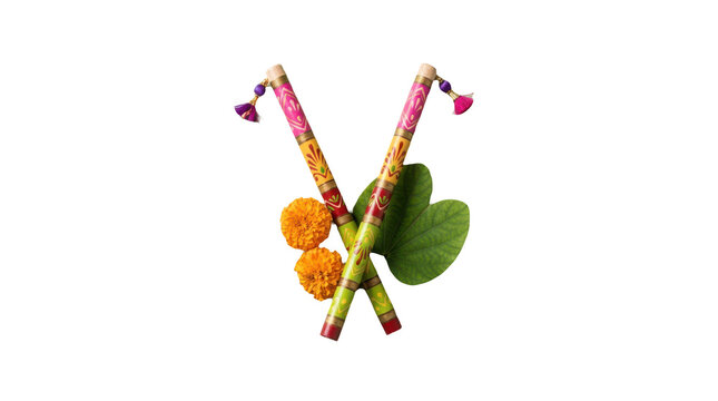 Colorful decorated dandiya sticks with marigold flowers and green leaves for navratri festival celebration