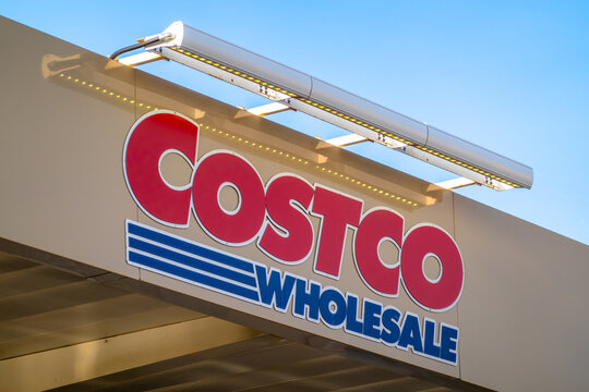 Los Angeles, CA, USA - Sept 13, 2026: Low-angle view of red and blue Costco Wholesale outdoor signage mounted on store facade under clear sky.
