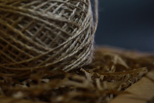 Rustic Twine Ball on Shredded Kraft Paper Background: Natural Crafting Material