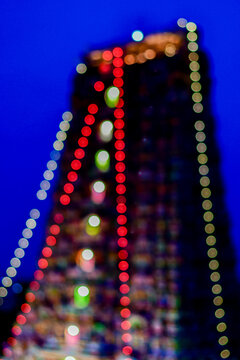 Artistic out-of-focus view of illuminated gopurams at Madurai Meenakshi Amman Temple ahead of the Thirukkudamuzuku and Kumbabhishekam sacred Hindu consecration ceremony