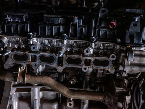 Close up of dirty car engine cylinder head intake ports with carbon deposits