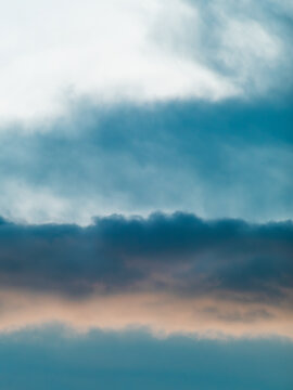 Dramatic Blue-Teal Storm Clouds with Warm Sunset Light Peeking Through