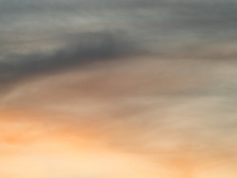 Abstract Soft Blurred Sunset Sky in Muted Orange and Gray Tones