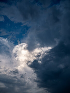 Dramatic Cumulus Clouds with Sunlight Breaking Through Blue Sky