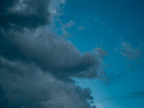 Moody Teal-Blue Storm Clouds Against Vivid Sky Gradient