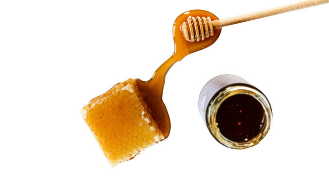 Fresh honeycomb with honey dripping from wooden dipper and jar transparent png